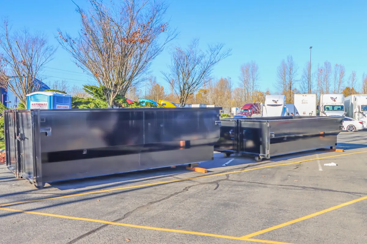 Professional dumpster rental service with roll-off container on residential driveway in Morrisville